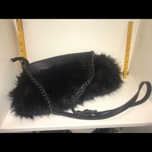 Faux fur, real leather, adj strap, hand muff bag.